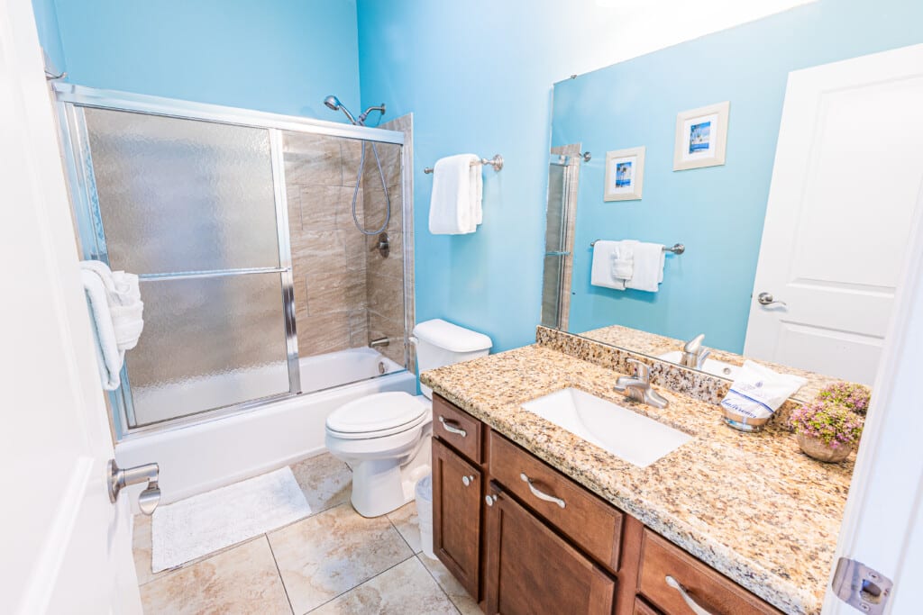 Bathroom 2 - Start or end your day by freshening up in this clean and functional bathroom with a spacious vanity and a shower/tub combination.