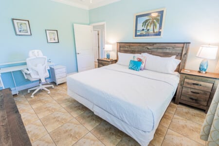 Primary Bedroom - Unwind in your comfortable King Bed, enjoy the privacy of your En-Suite Bathroom, and end the day watching your favorite shows on TV.
