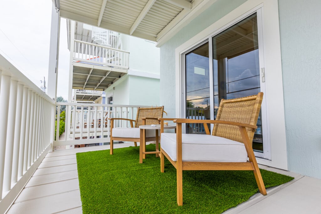 Enjoy your morning coffee on this cozy balcony with a fresh outdoor feel
