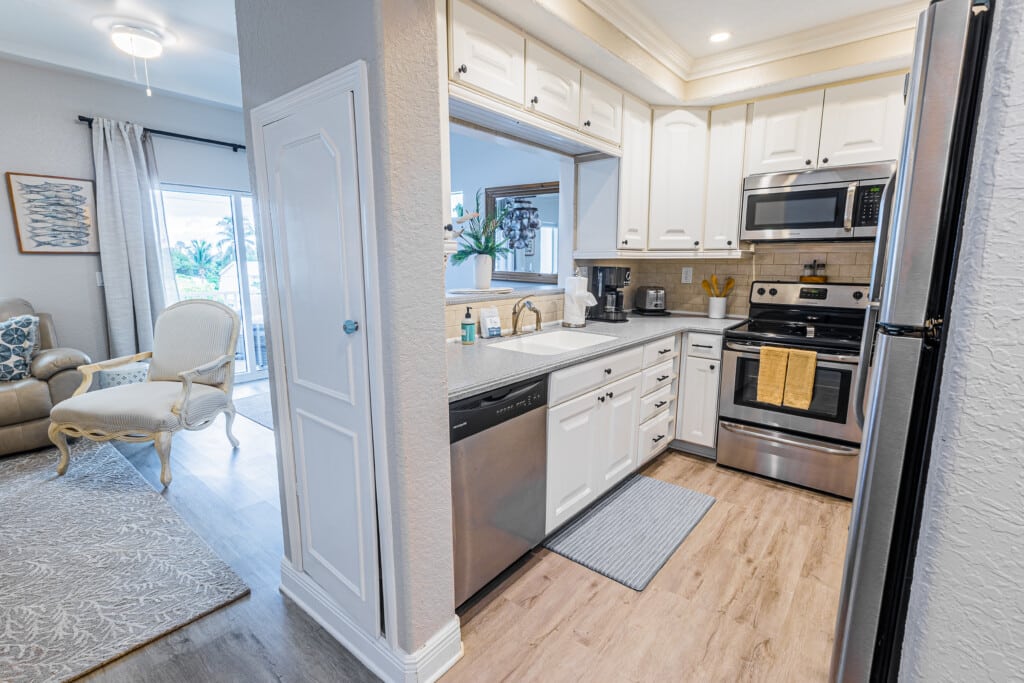Feel right at home in this sparkling clean kitchen with crisp white cabinetry and beautiful finishes.