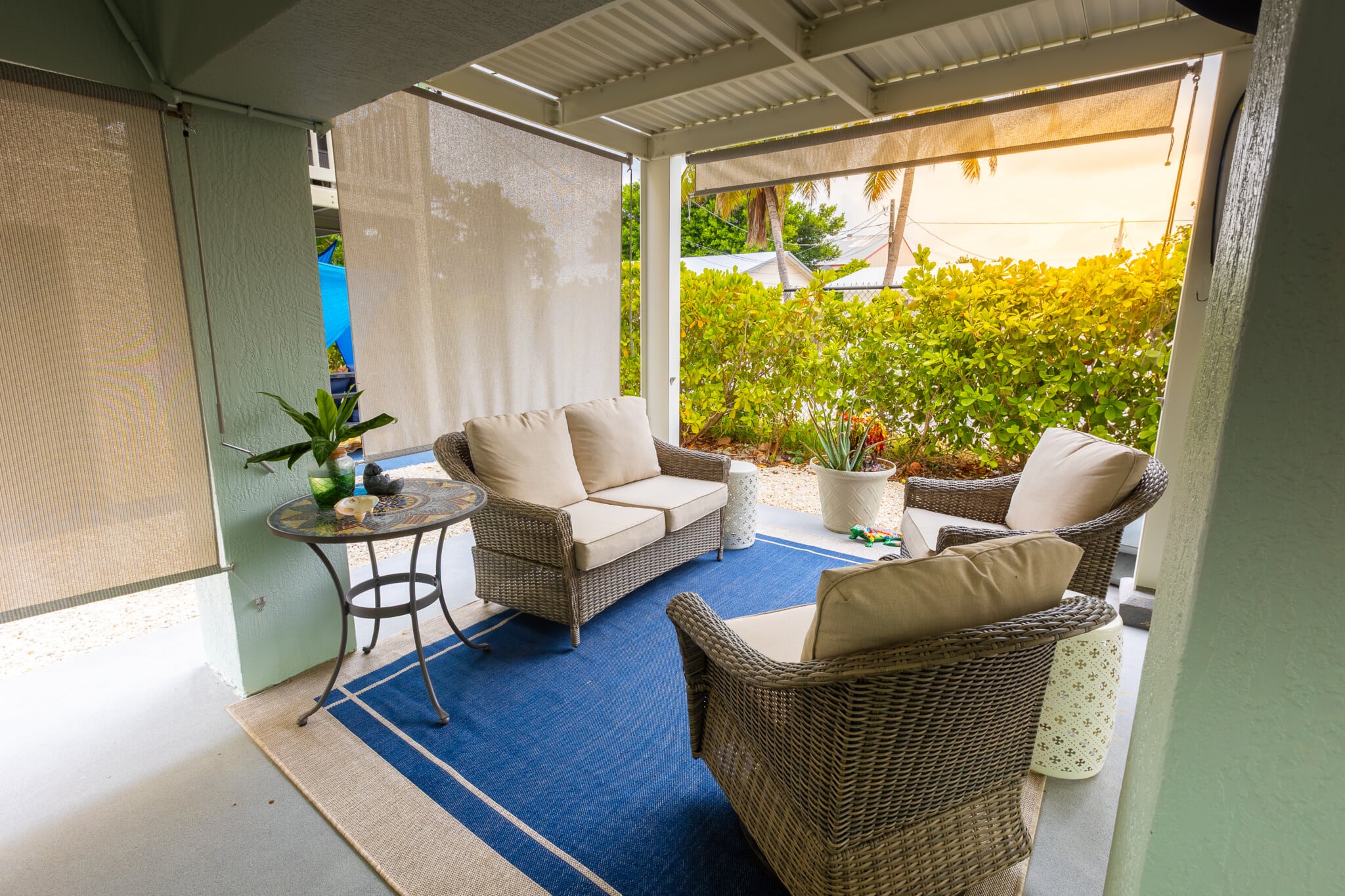 Start your day with a fresh breeze in this cozy, covered outdoor lounge.